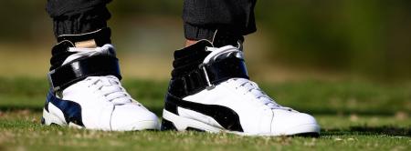 Rickie Fowler wears high tops and tracksuit while playing